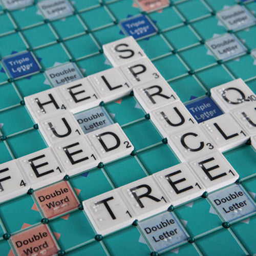 Braille and large print Scrabble board with a game in play