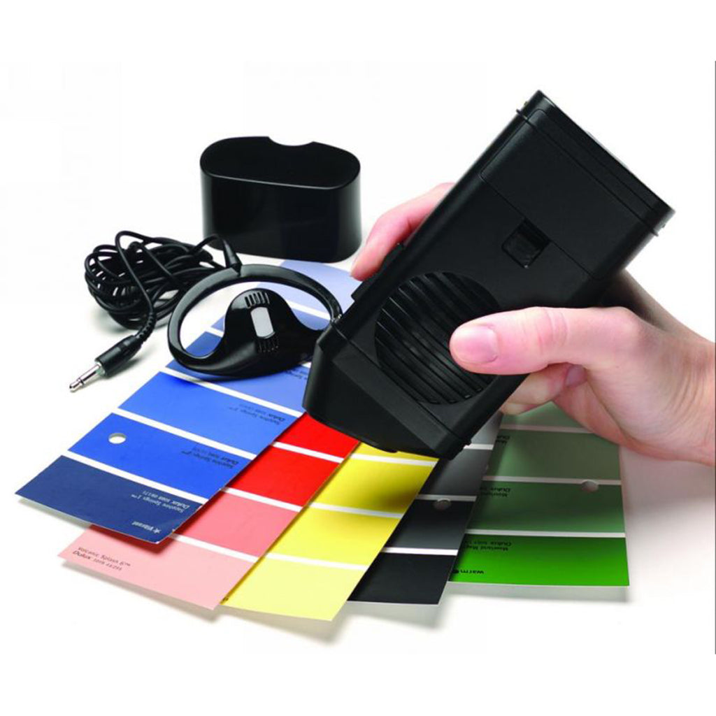 A person using the Talking Colour Detector to detect colours of paint sample cards