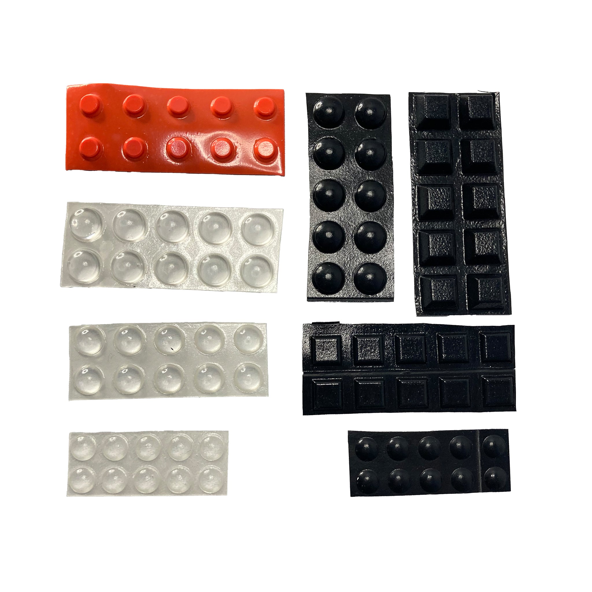 A selection of black, white and orange self-adhesive rubber dots against a white background