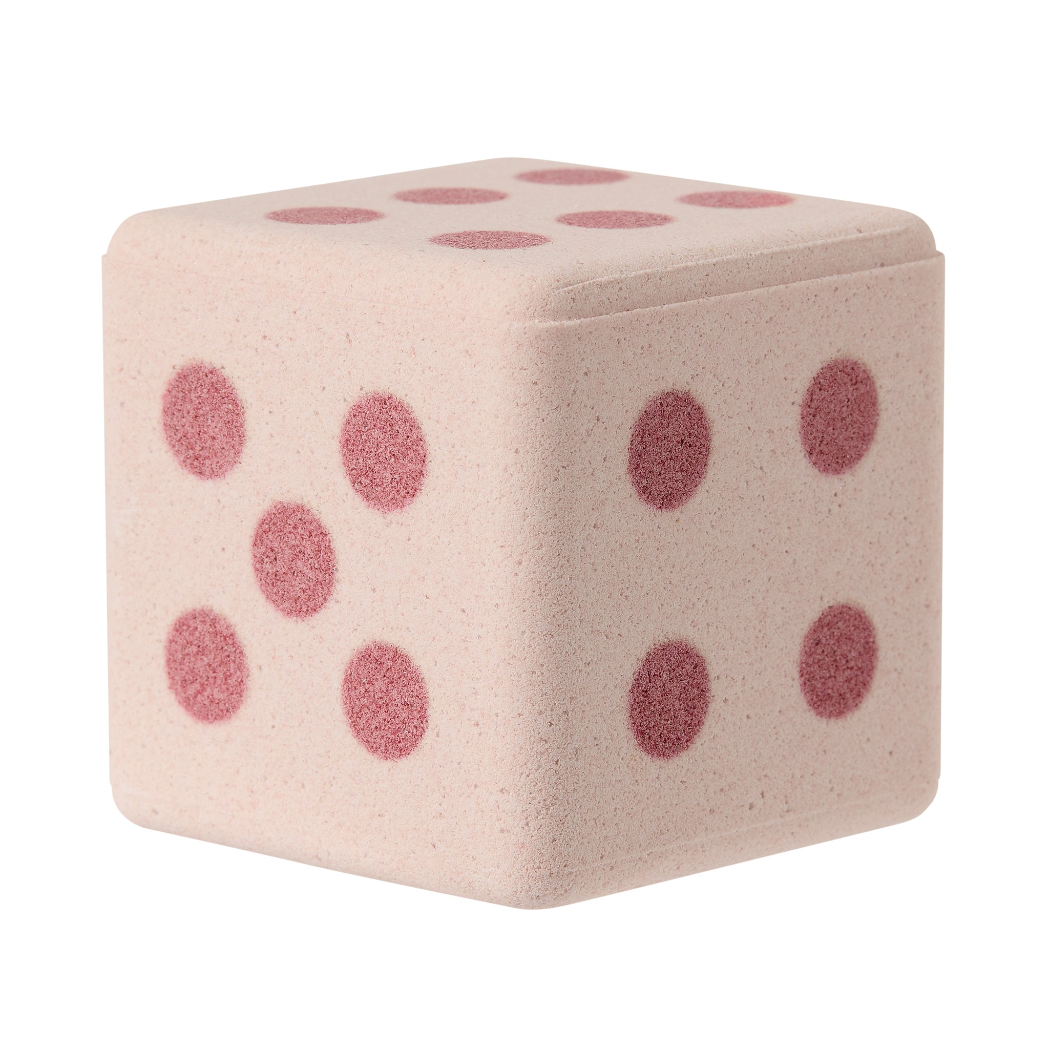 Pink dice-shaped bath bomb on a white background