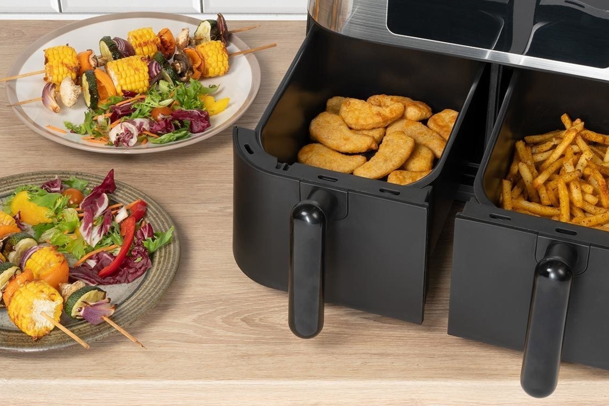 Two tray air fryer cooking chickena and chips