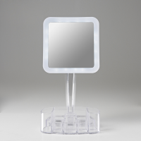 Front view of square mirror with clear plastic tray against a grey backgorund