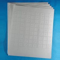 Braille sudoku puzzle sheets fanned on a blue background