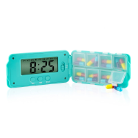 A turquoise super 8 daily pill organiser open to show digital display and pill compartments