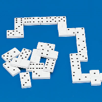 White dominoes with raised black dots on a blue background