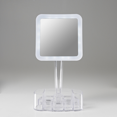 Front view of square mirror with clear plastic tray against a grey backgorund