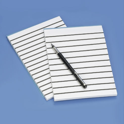 Close-up of lined paper with lines 1.7cm apart with a pen