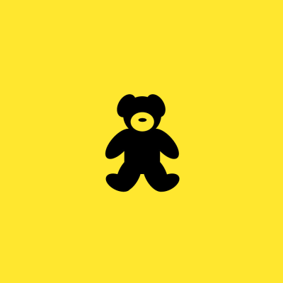 Black teddy bear on a yellow background.