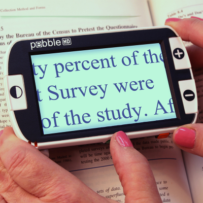 A person reading handwriting on 3 Inch handheld video magnifier