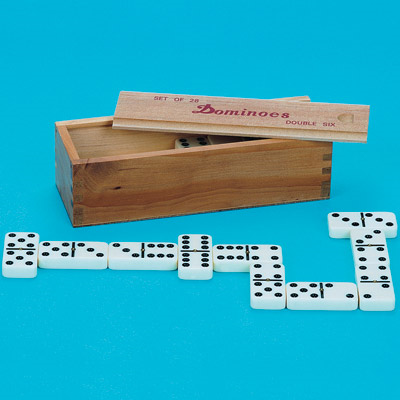 White dominoes with black dots in front of the wooden storage case