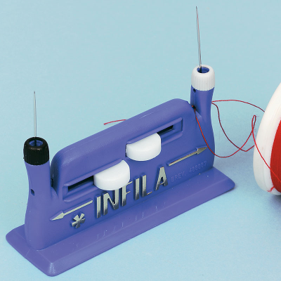A blue automatic needle threader next to some visible red thread