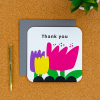 Thank You card  on a desk with pen next to it