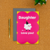 Daughter birthday card on a desk with pen next to it