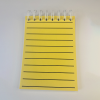 RNIB A6 Spiral Yellow notebook showing open page and lines