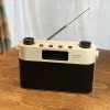 RNIB digital radio with aerial extended on a wooden table