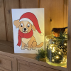 Inclusive Christmas puppy Christmas card on a shelf with Christmas decorations