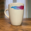 RNIB mug on a breakfast bar showing the blue and purple part of the design