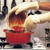 Close-up of a person using the gloves while cooking