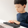 A child using the Brailliant BI40X with headphones