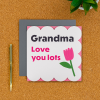 Grandma birthday card on a desk with pen next to it