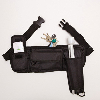 Black belt-pack cane holster with a cane; keys and a mobile phone in pockets