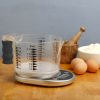 Talking kitchen scale with easy-to-see jug on a table with baking ingredients