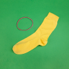 A bright yellow sock and elastic band on a green background