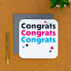 Congratulations card on a desk with pen next to it
