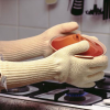 Close up of a person using the gloves while cooking
