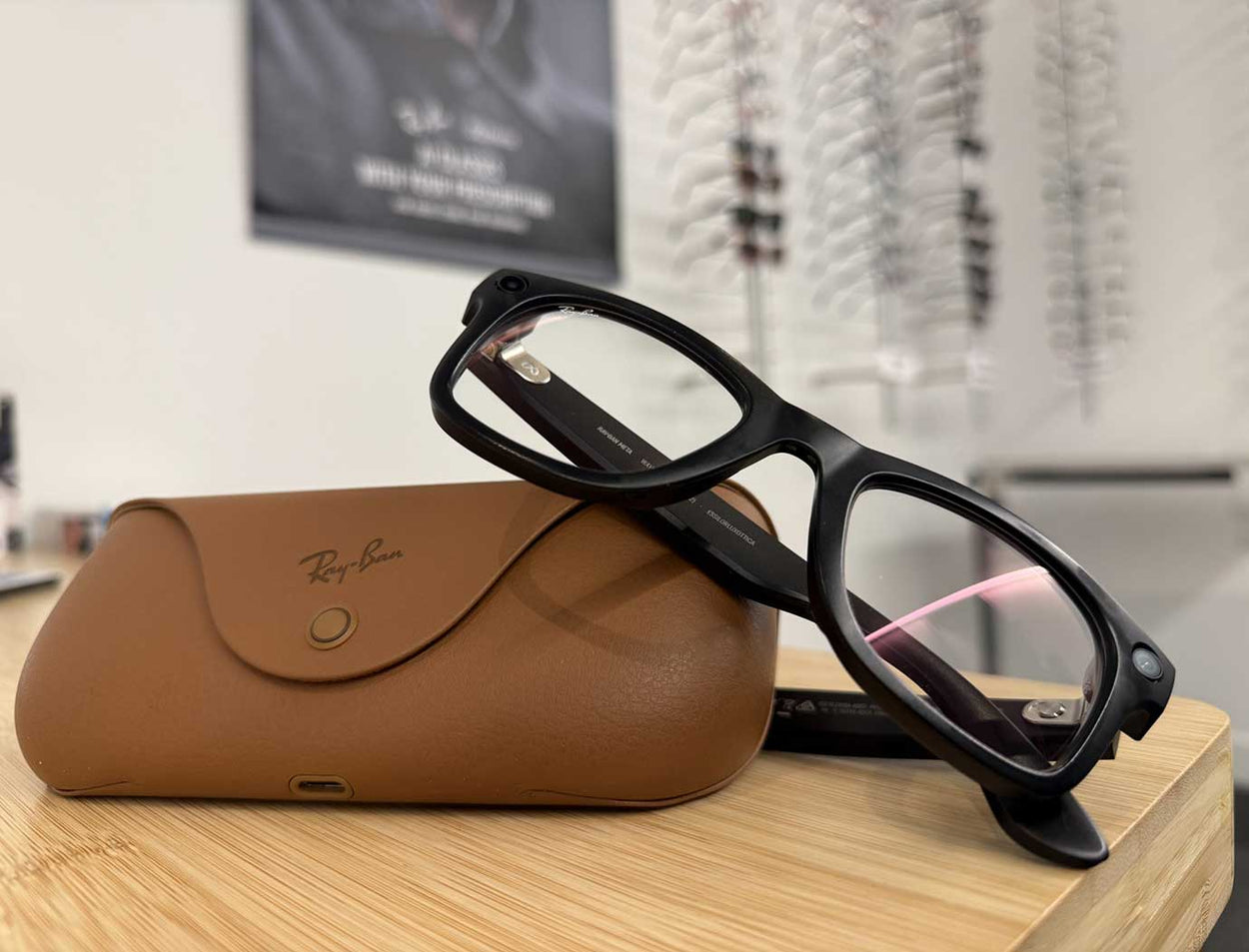 Pair of Ray-Ban Meta glasses resting on their protective leather case inside an eye clinic