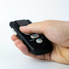 Hand holding the Black Ikonn Controller  against a white background