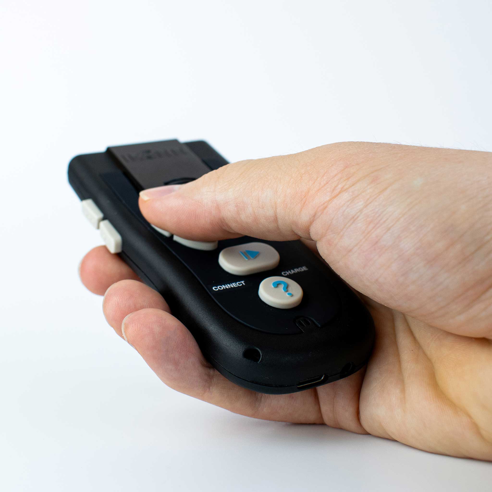 Hand holding the Black Ikonn Controller  against a white background