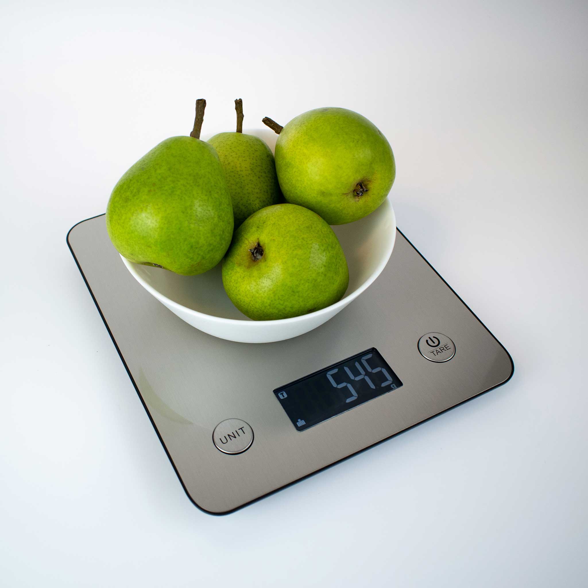 Ikonn kitchen scale with a bowl of green pears on a white background