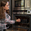 Woman checking food in an oven using the Ikonn kitchen thermometer.