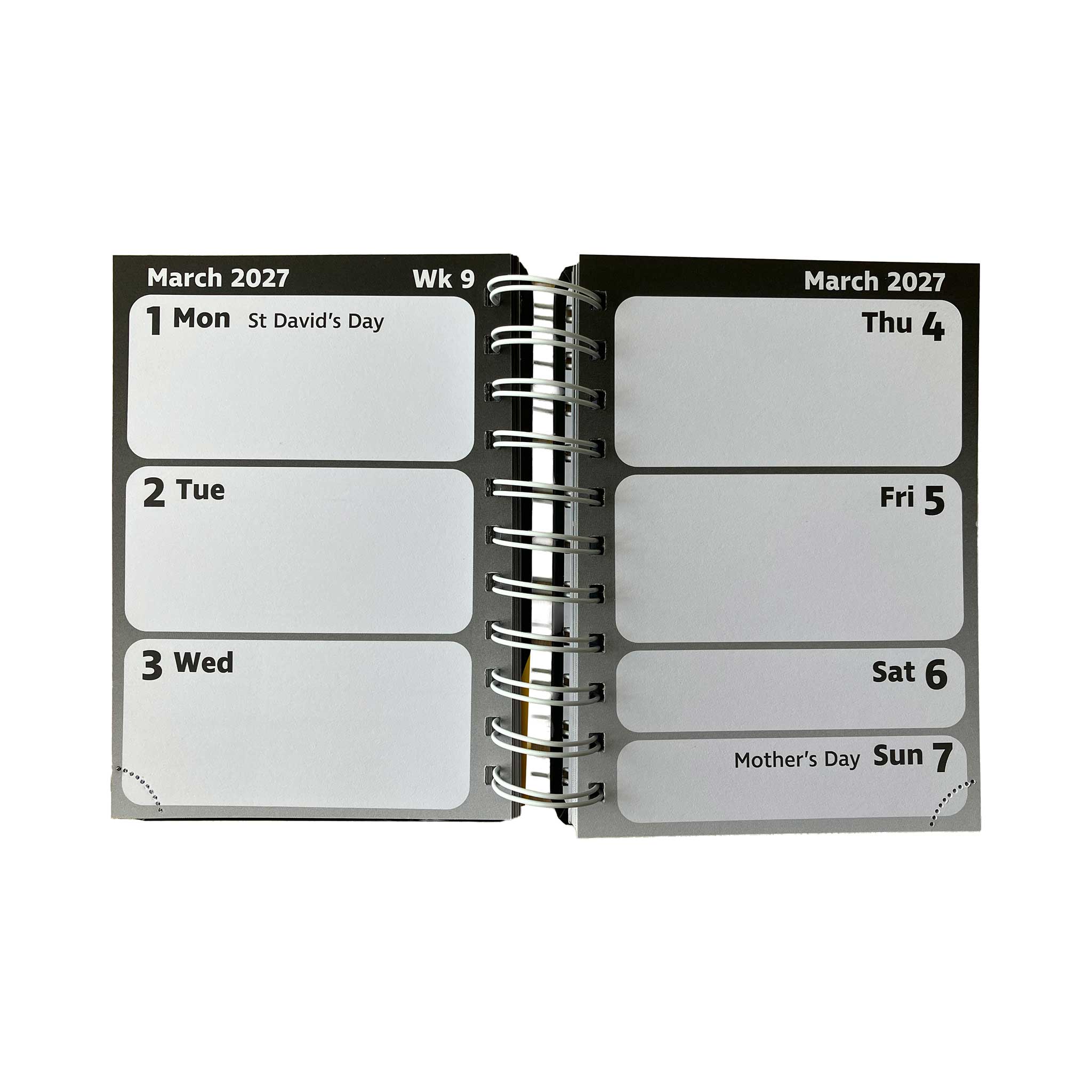 An open spiral-bound pocket diary page showing dates from March 2027 with labeled boxes for Monday through Sunday, photographed on a plain white background.