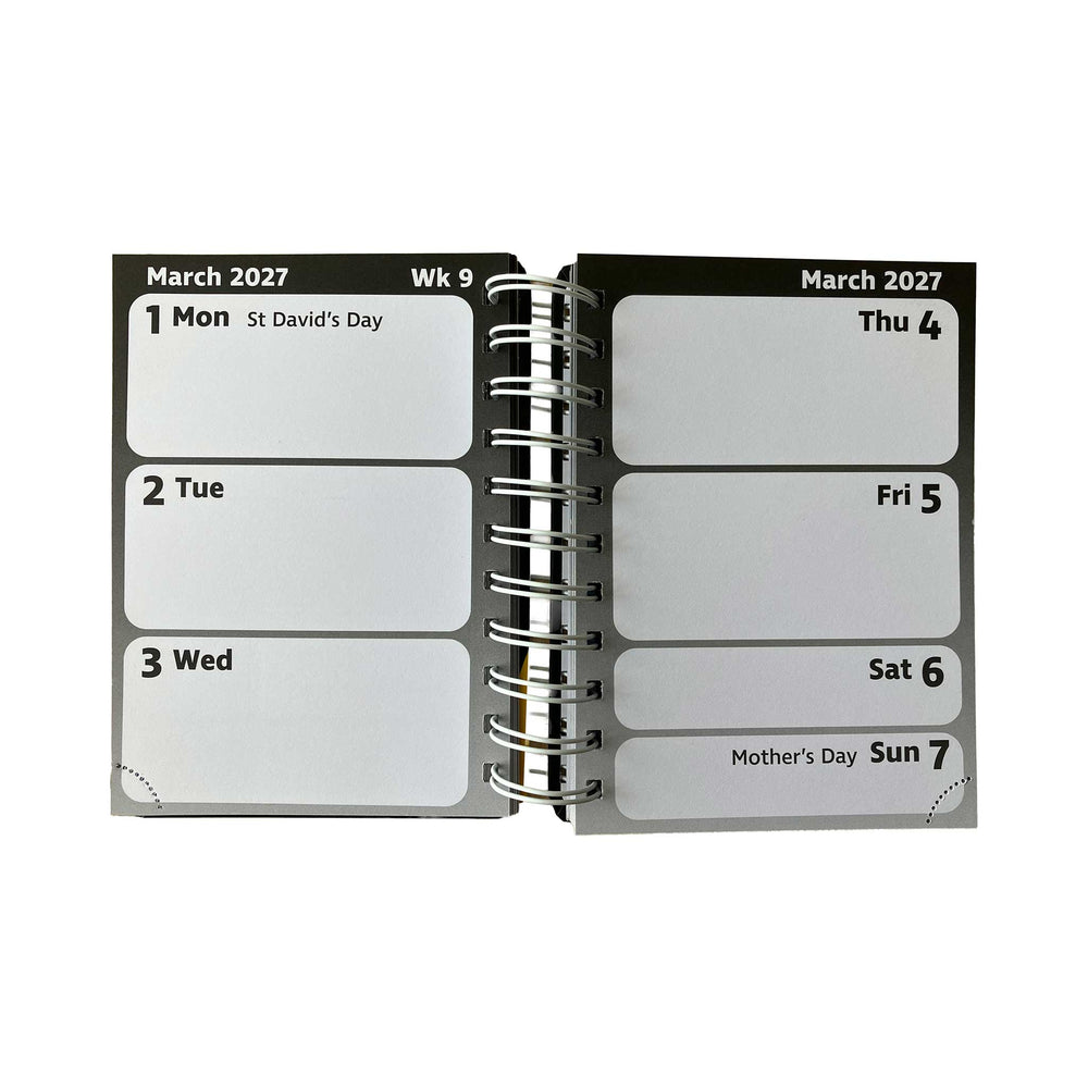 An open spiral-bound pocket diary page showing dates from March 2027 with labeled boxes for Monday through Sunday, photographed on a plain white background.