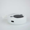 Ikonn tape measure on a white surface with the charging lead attached.