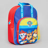 A Paw Patrol themed children's backpack featuring a red body, blue top panel, yellow front accent, and character graphics on the front pocket. The straps are blue with white Paw Patrol text, and the backpack is photographed on a neutral light gray background.