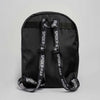 A black backpack with prominent black webbing shoulder straps printed with 'SPIDER-MAN' in white, shown against a neutral light gray background.