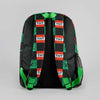 A black backpack featuring a green and red checkered TNT block pattern, shown from the back against a neutral gray background.