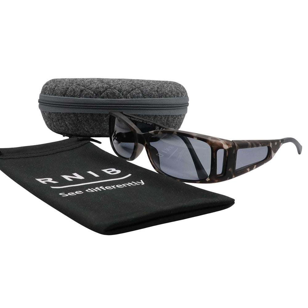 Eyeshiedls with grey lenses and a carrying case on a white background, featuring the RNIB logo.