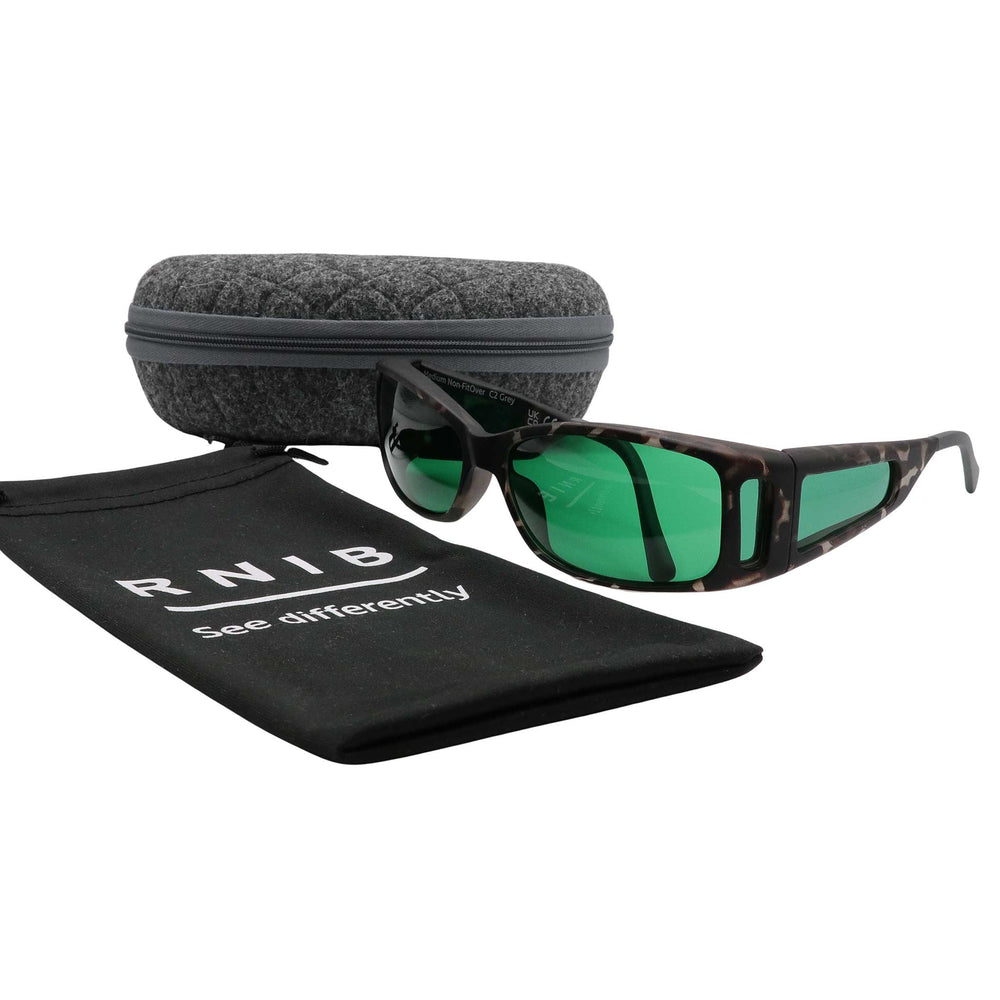Eyeshiedls with green lenses and a carrying case on a white background, featuring the RNIB logo.