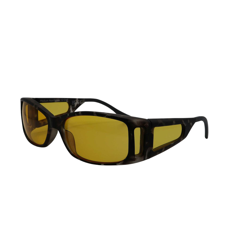 Side angled view of RNIB medium Eyeshield glasses with grey tortoiseshell frames and yellow tinted lenses.