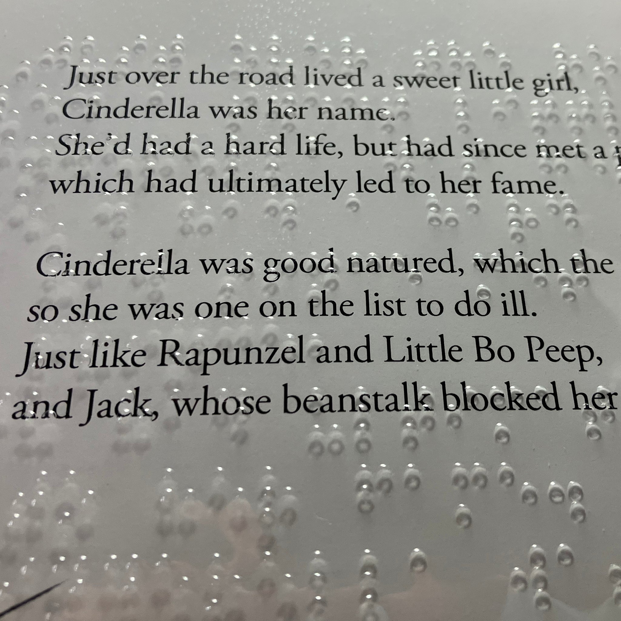 Braille on a clear plastic sheet over the original text of the book