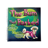 Book cover of 'The Bum That Barked' with a dog illustration on a blue background