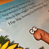 Children's book page with a cartoon worm with text and braille about Superworm.