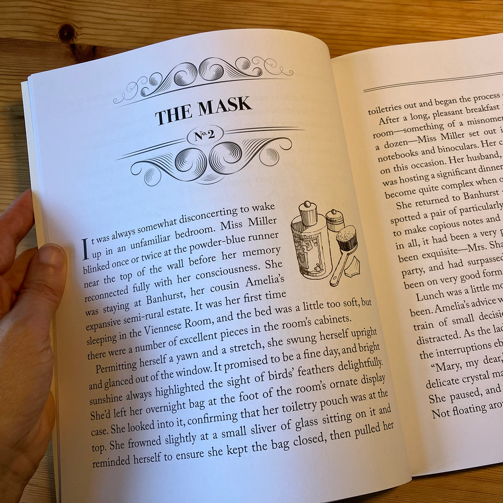 Open book with a page titled 'The Mask' held by a hand on a wooden surface