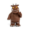 Brown cartoon-like creature with yellow eyes and white teeth on a white background