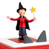 Toy figure of a witch with a broom on a white background