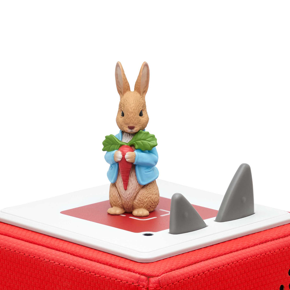 Toy figure of a rabbit holding a carrot on top of a red Tonie box